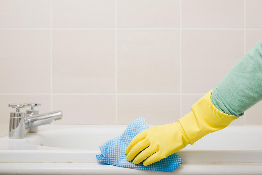 Person cleaning bath Photograph by Image Source
