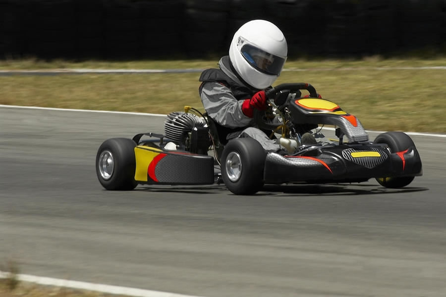 Person driving a go-cart on a motor racing track Photograph by Glowimages