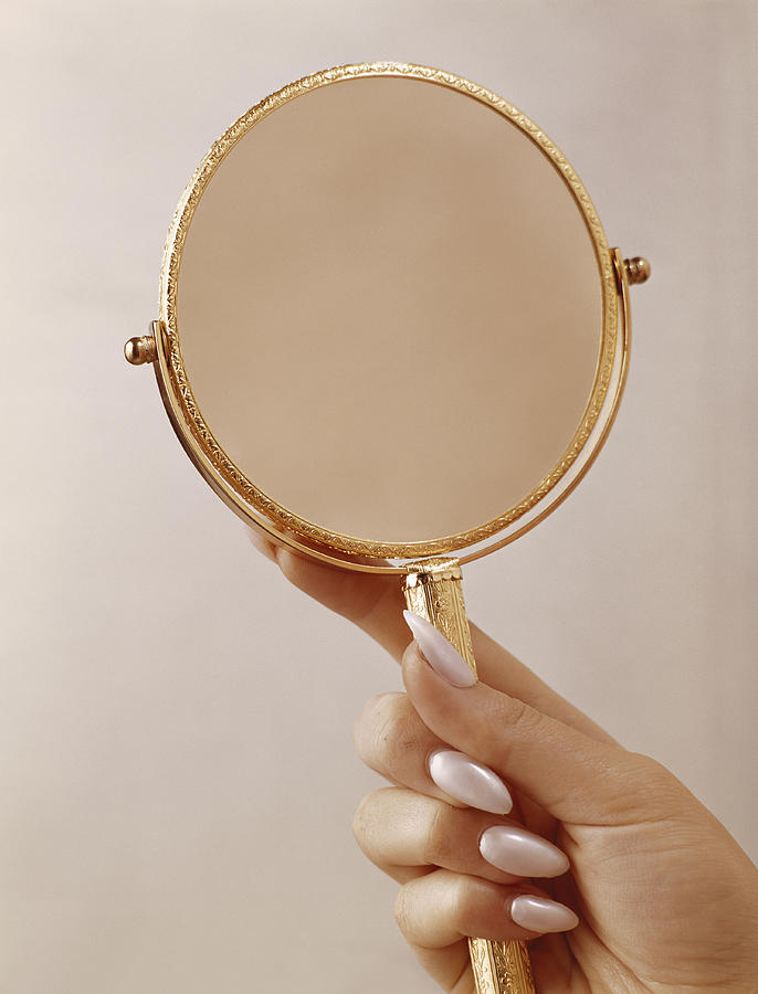 Person holding mirror, close up Photograph by Tom Kelley Archive