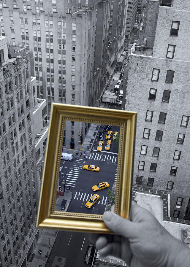 Person holding picture frame framing traffic Manhattan taxis, close-up of hand Photograph by Grant Faint