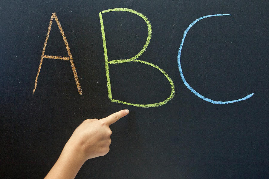 Person pointing to ABC on a blackboard Photograph by Geri Lavrov