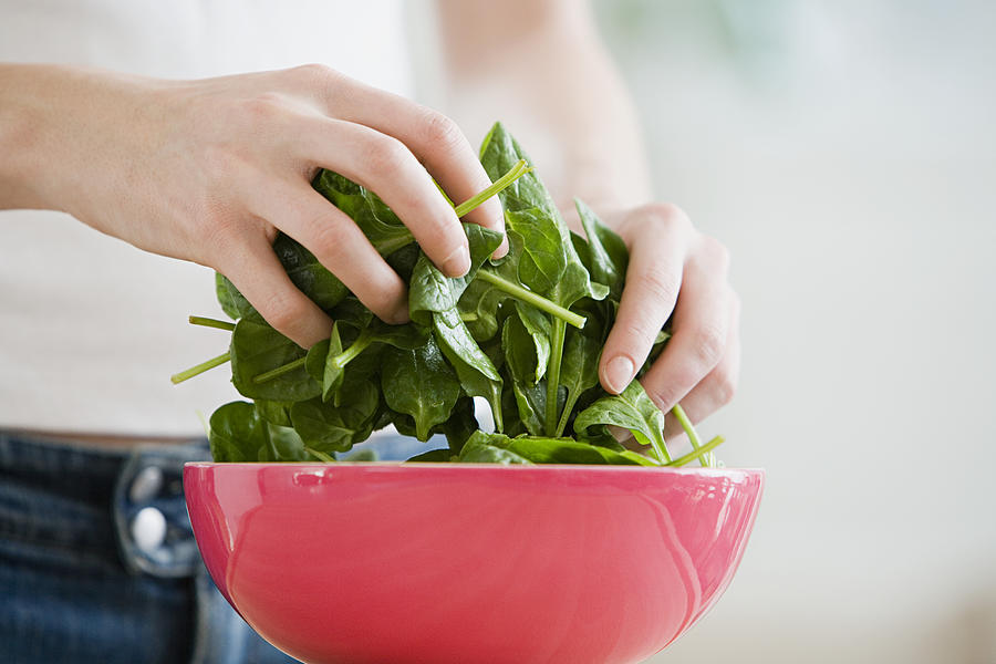 Person preparing spinach Photograph by Image Source