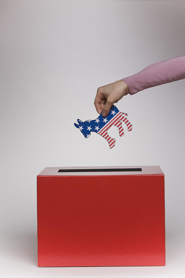 Person putting political symbol in box Photograph by Comstock Images