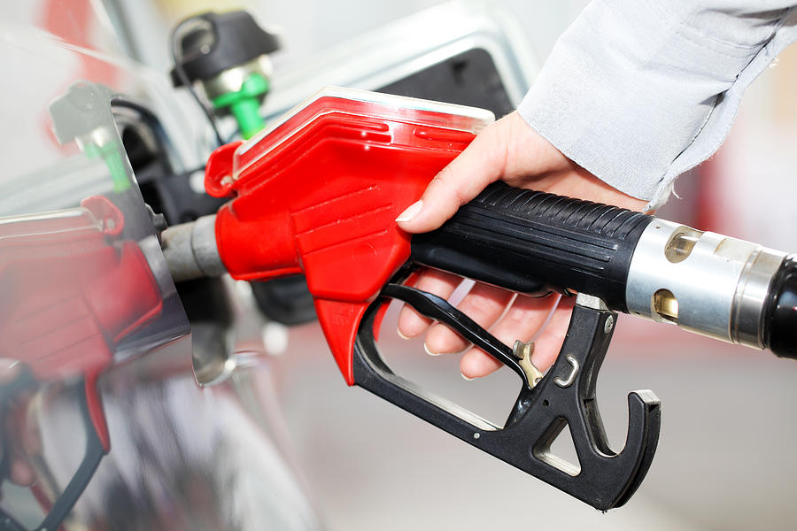 Person refueling a car at gas station. Photograph by Skynesher Person refueling a car at gas station. Photograph by Skynesher