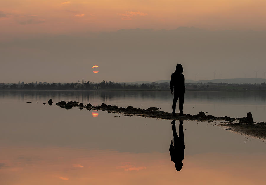 Person standing and enjoying the sunset at a lake. Larnaca Cyprus Photograph by Michalakis Ppalis