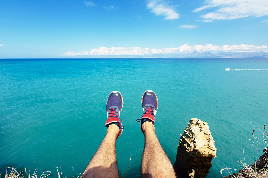 Personal perspective of mans feet against blue sea and sky Photograph by Alexander Spatari