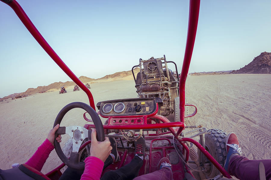 Personal perspective view of two people driving beach buggy in desert, Hurghada, Al Bahr al Ahmar, Egypt Photograph by Chuvashov Maxim