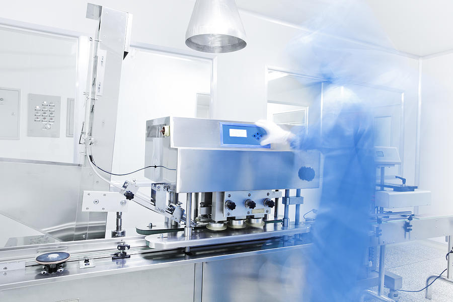 Pharmaceutical equipment with technician in blue Photograph by 4X-image