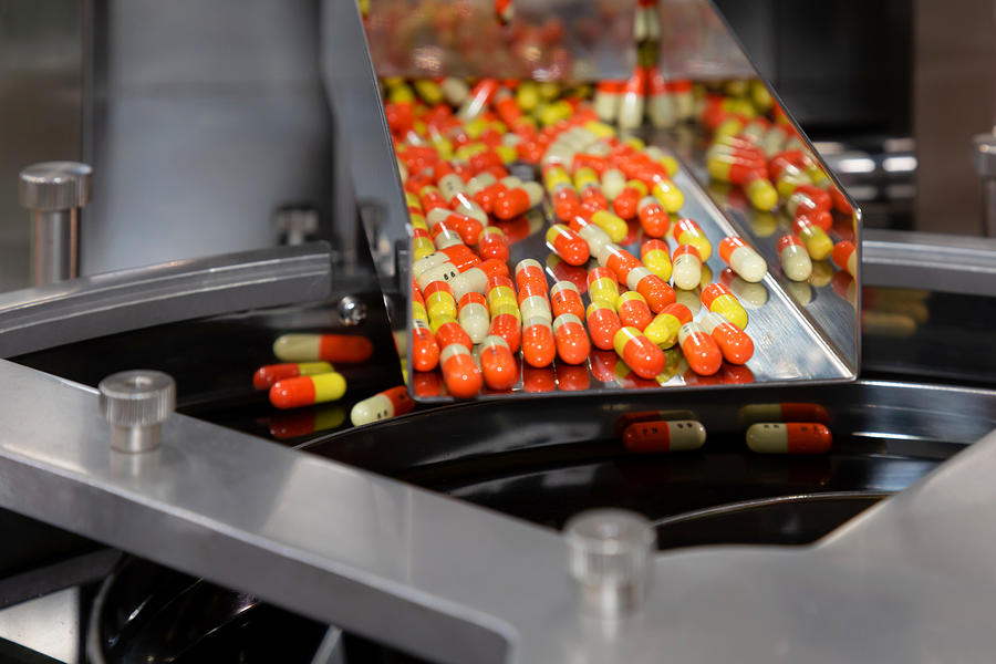 Pharmacy Medicine Capsule Pill In Production Line At Medical Factory. Selective Focus. Photograph by Gumpanat
