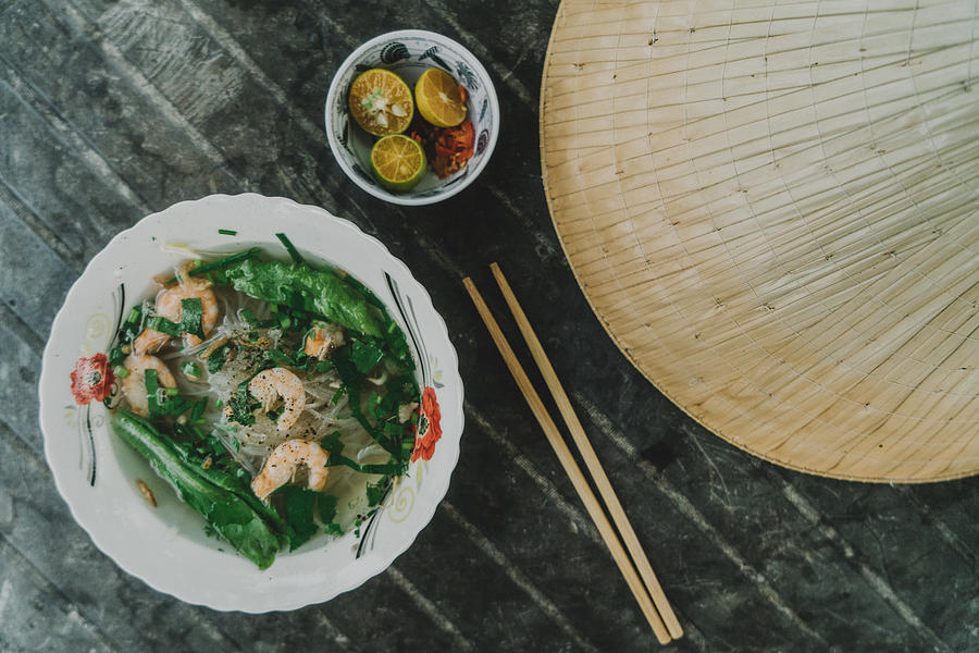 Pho with shrimp on the table near Asian conical hat Photograph by Oleh_Slobodeniuk