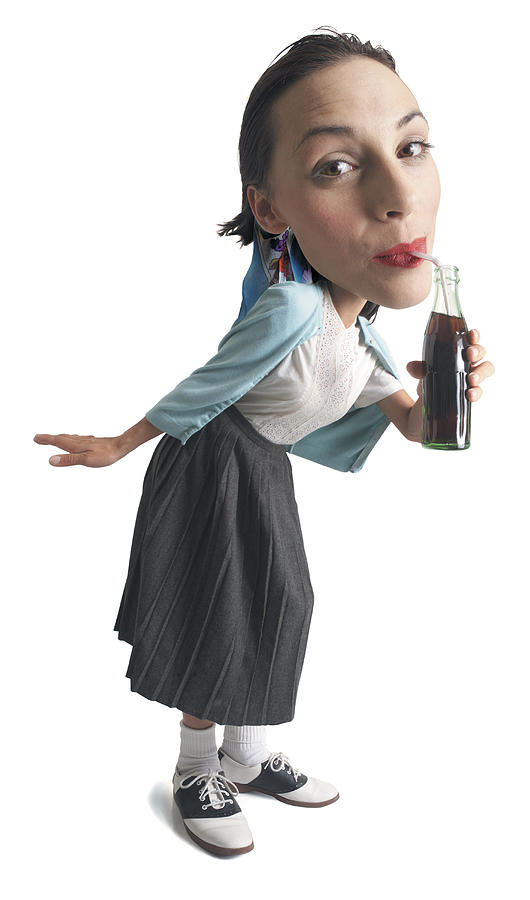 Photo Caricature Of A Young Girl Dressed In 50s Retro Clothes Leans In Drinks From A Soda Bottle Photograph by Photodisc