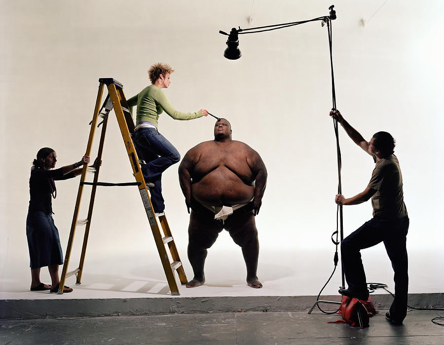 Photo crew preparing sumo wrestler for filming Photograph by Emmanuel Faure