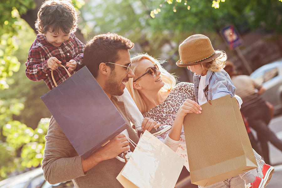 Photo of a young beautiful family enjoying shopping Photograph by Geber86