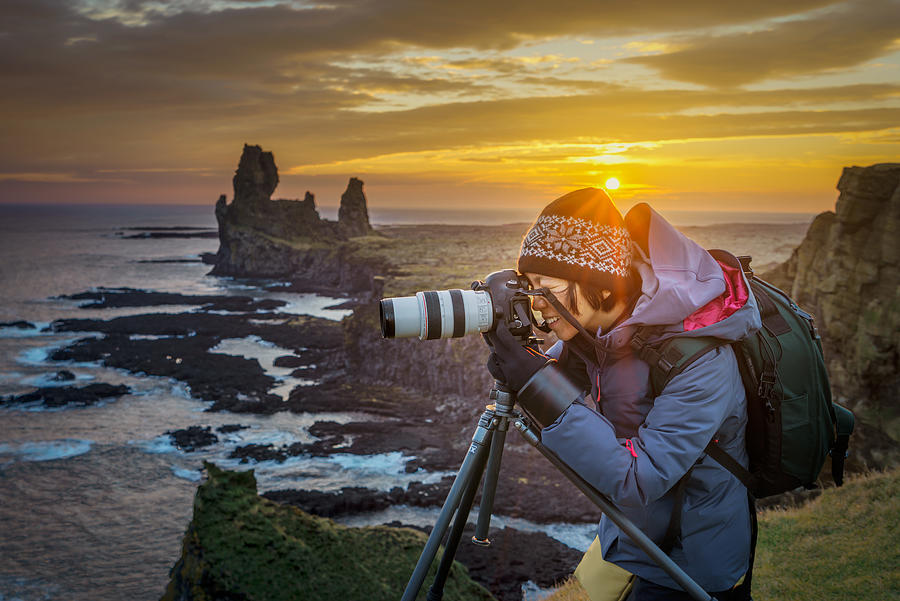 Photographer taking pictures at sunset, Iceland Photograph by Arctic-Images