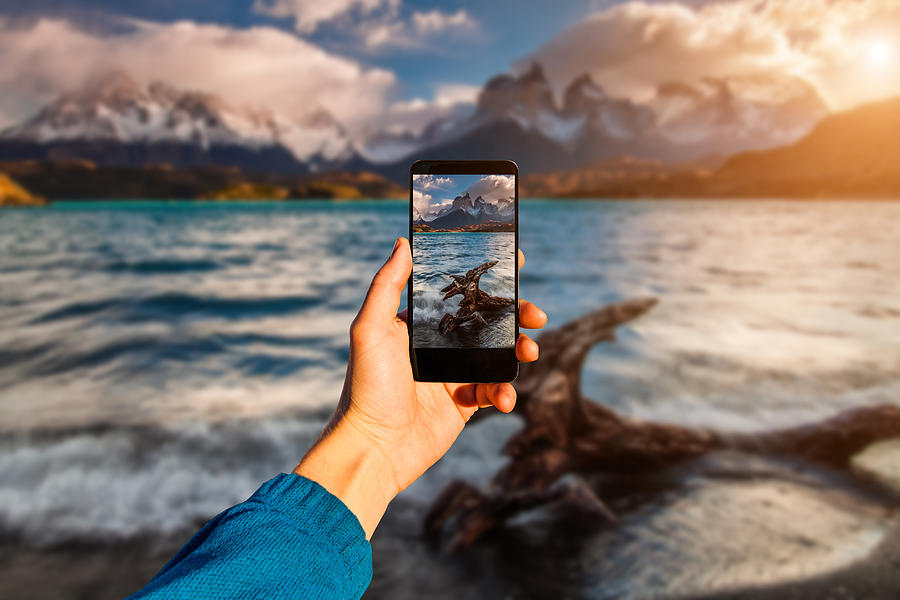 Photographing with smartphone in hand. Travel concept. Torres del Paine, Chili Photograph by Anton Petrus