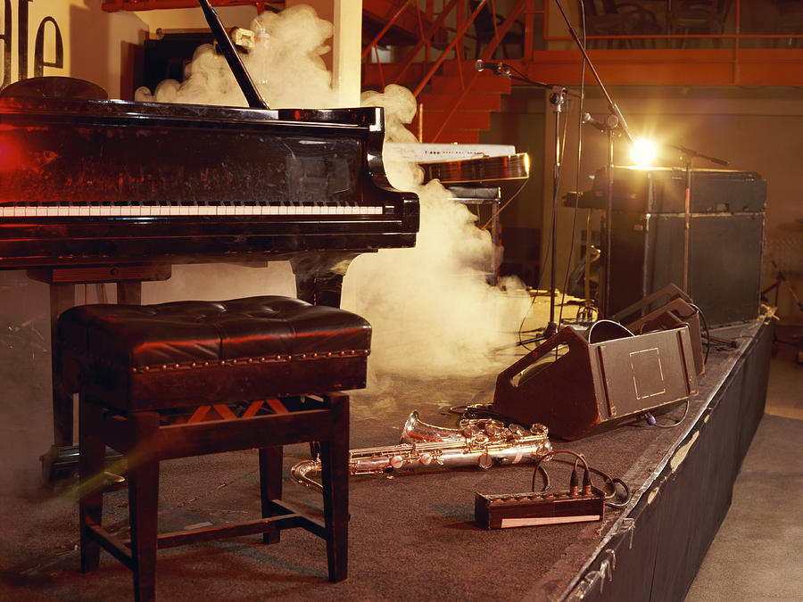 Piano, Saxophone and Microphone Stands on a Smoky Stage Photograph by Digital Vision.