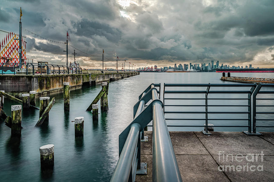 Pier in the port with poles in the water and cloudy afternoon. Vancouver Photograph by Jose Rey