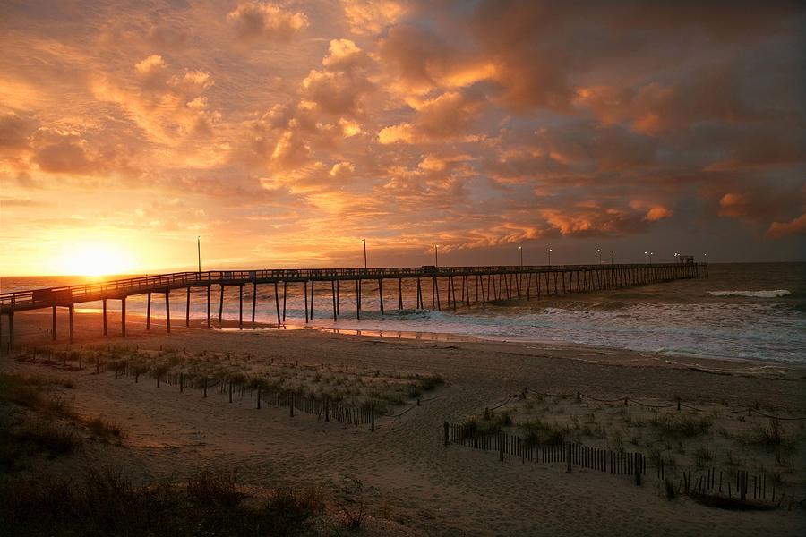 Pier on beach at sunrise, Oak Island, North Carolina Photograph by Jupiterimages