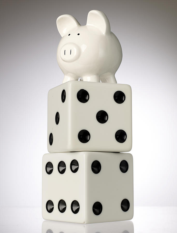 Piggy bank and dice Photograph by Tony Cordoza