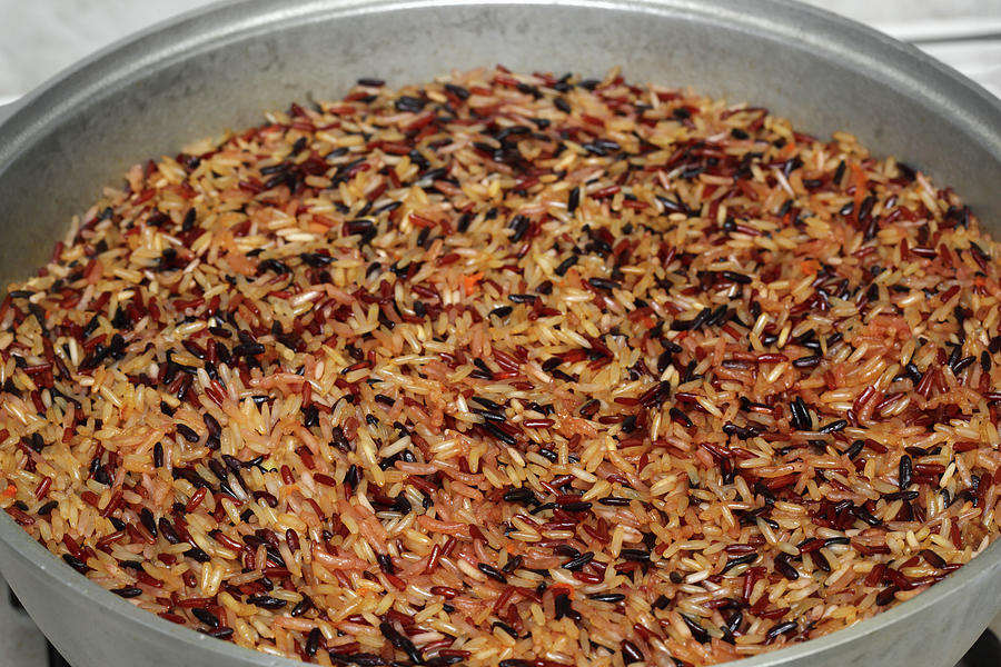 Pilaf of colored rice is cooked in cauldron Photograph by Mikhail ...