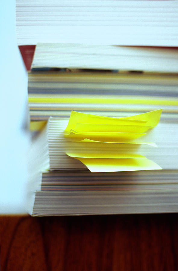 Pile of books, one with bookmarks sticking out, close-up Photograph by Jorg Greuel