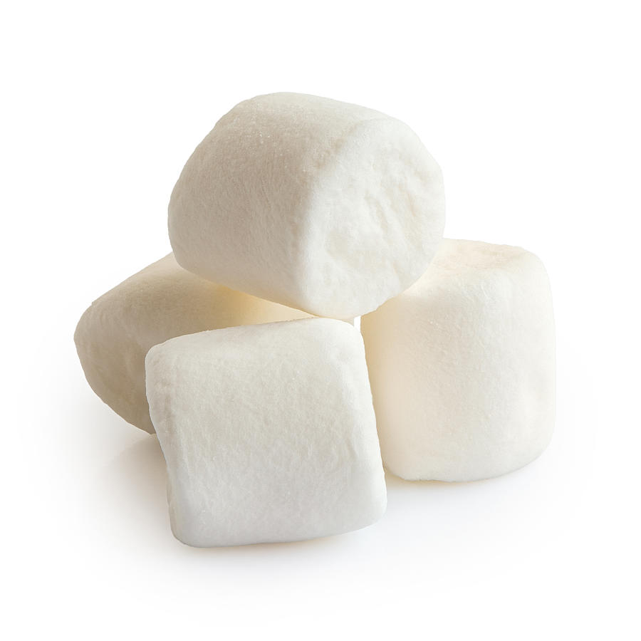 Pile of four white mini marshmallows isolated on white. Photograph by Etienne Voss