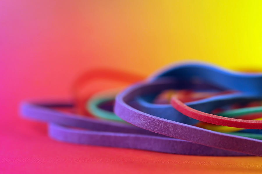 Pile of Rubber Bands on Rainbow Background Photograph by Adrienne Bresnahan