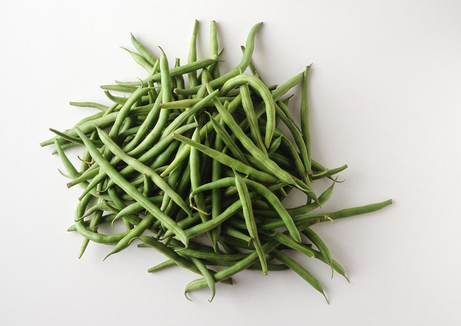 Pile of string beans, white background Photograph by Isabelle Rozenbaum & Frederic Cirou
