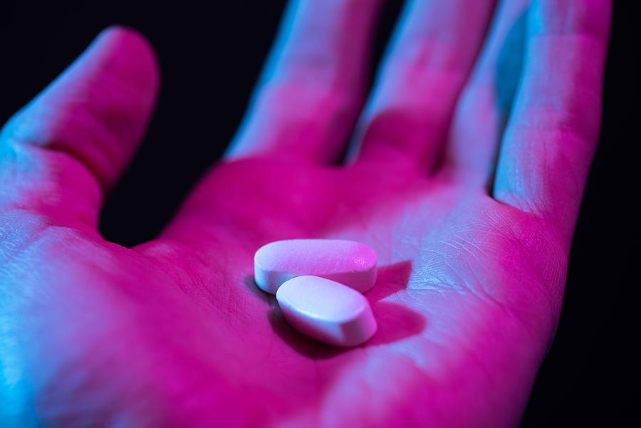 Pills in hand. Two drug tablets in palm Photograph by Nevodka