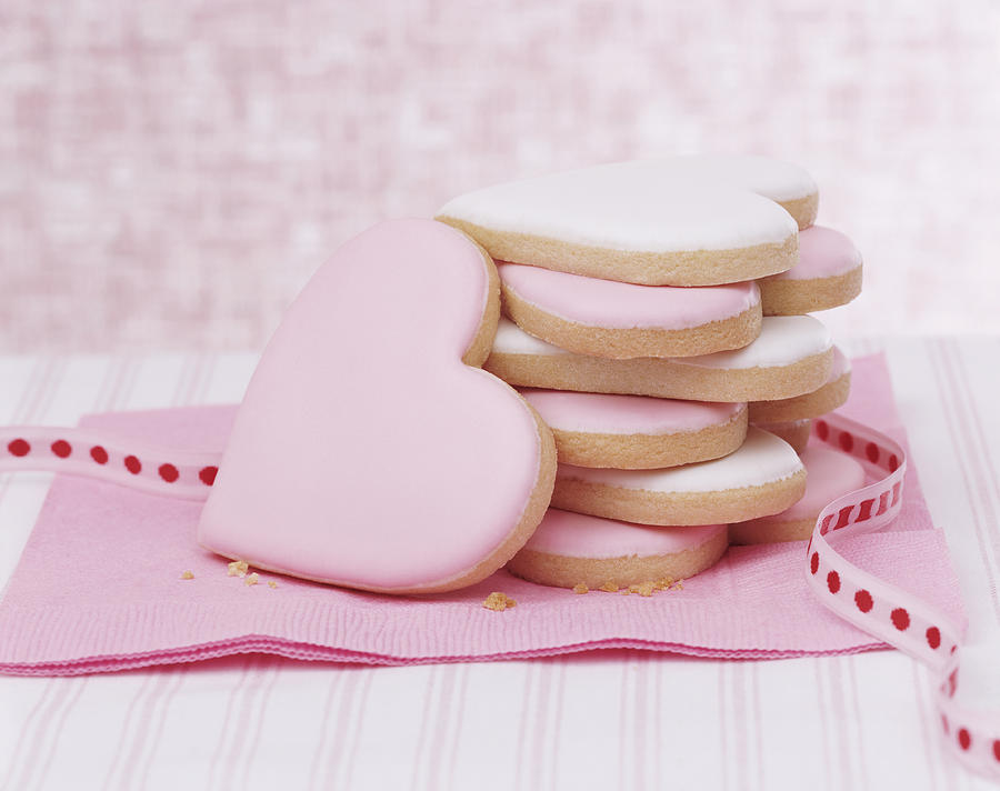 Pink Heart Shaped Cookies and a Ribbon on a Napkin Photograph by Digital Vision.