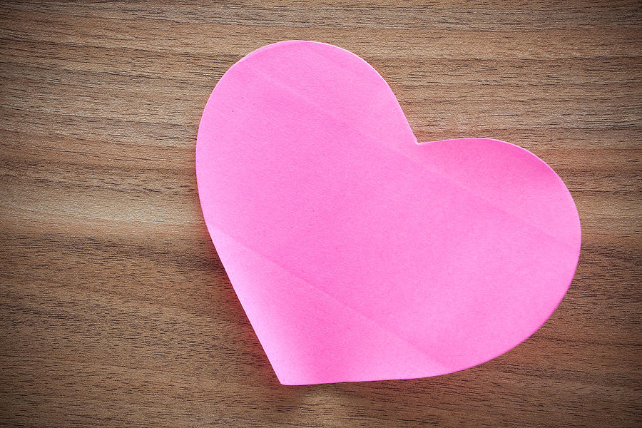 Pink paper heart shape on wood background Photograph by Hudiemm