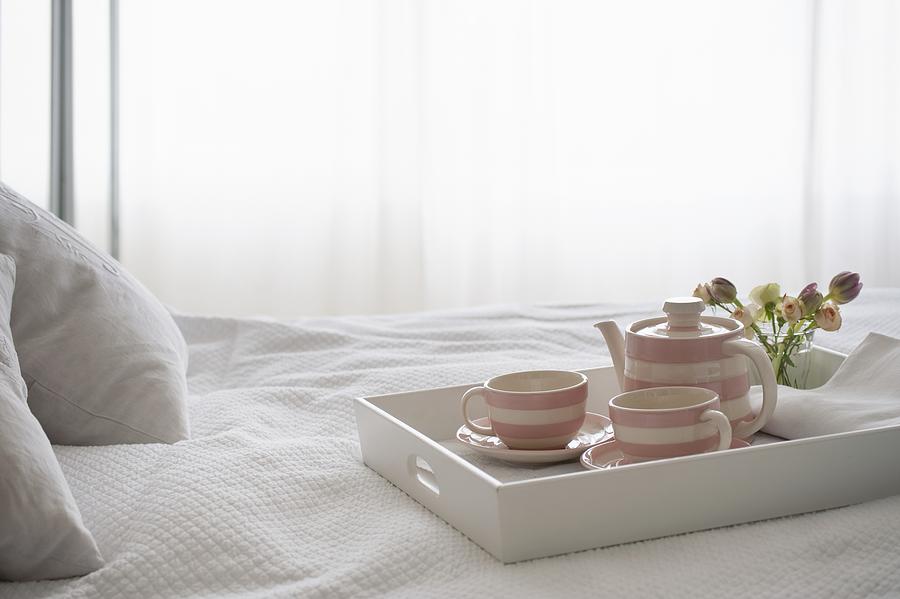 Pink striped teaset on breakfast tray Photograph by Moodboard