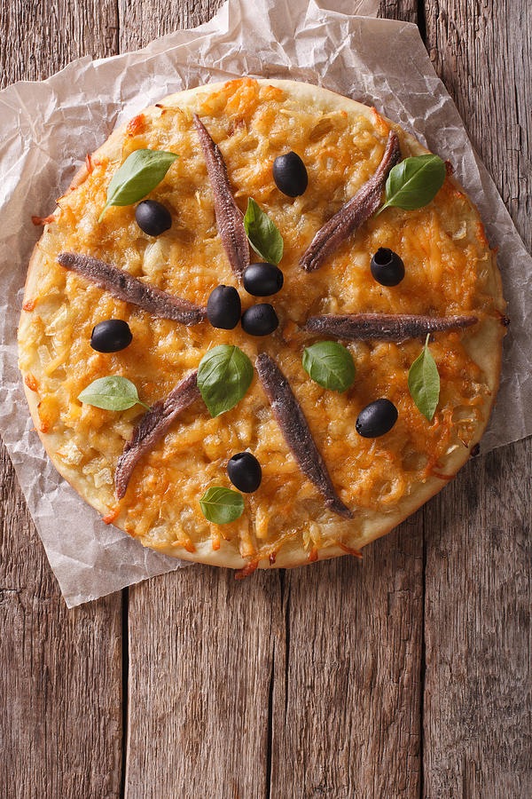 Pissaladiere with anchovies, olives and onion. vertical top view Photograph by Alleko