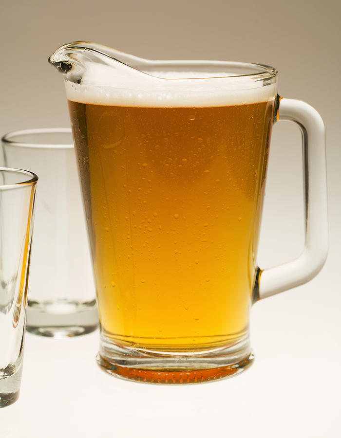 Pitcher of beer and two empty glasses, close-up Photograph by Barry Wong