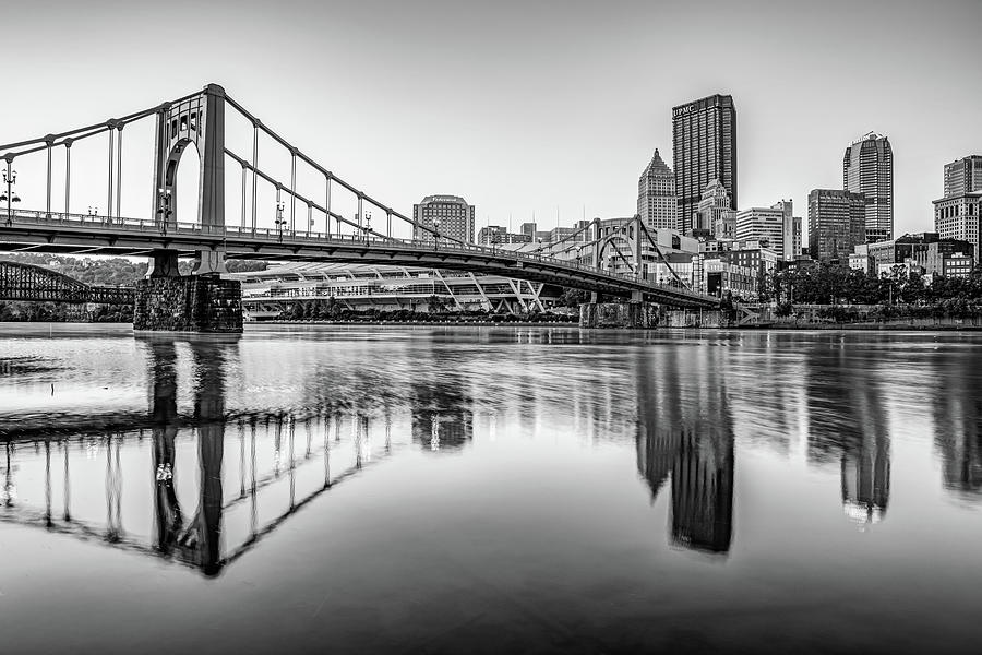 Pittsburgh Skyline Reflections And Carson Bridge At Sunrise - Black and White Photograph by Gregory Ballos