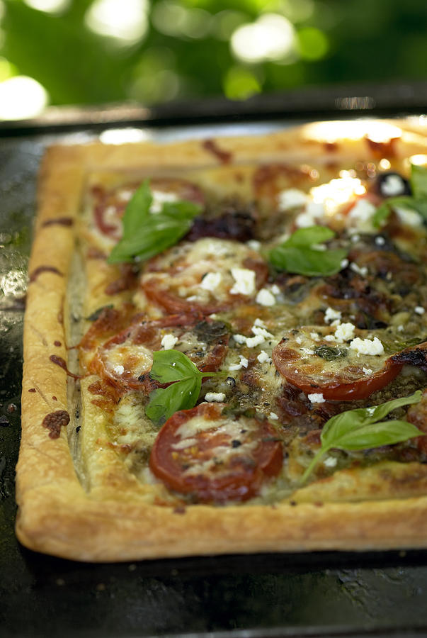 Pizza with tomatoes and basil on tray, close-up Photograph by Heidi Coppock-Beard
