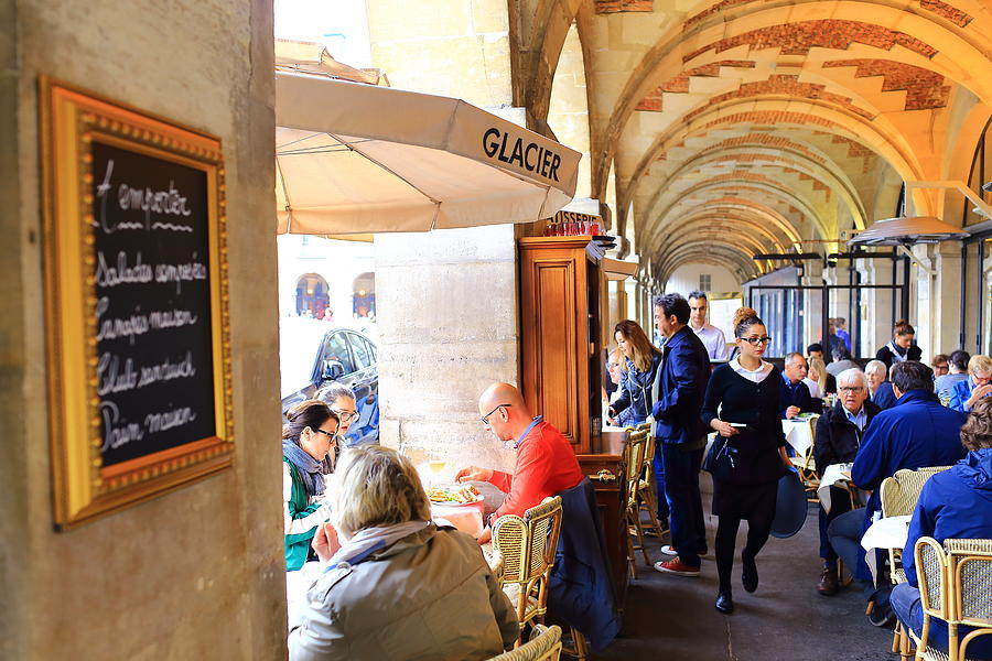 Place de Vosges (square), café under the arcade Photograph by Stefano Amantini/Atlantide Phototravel