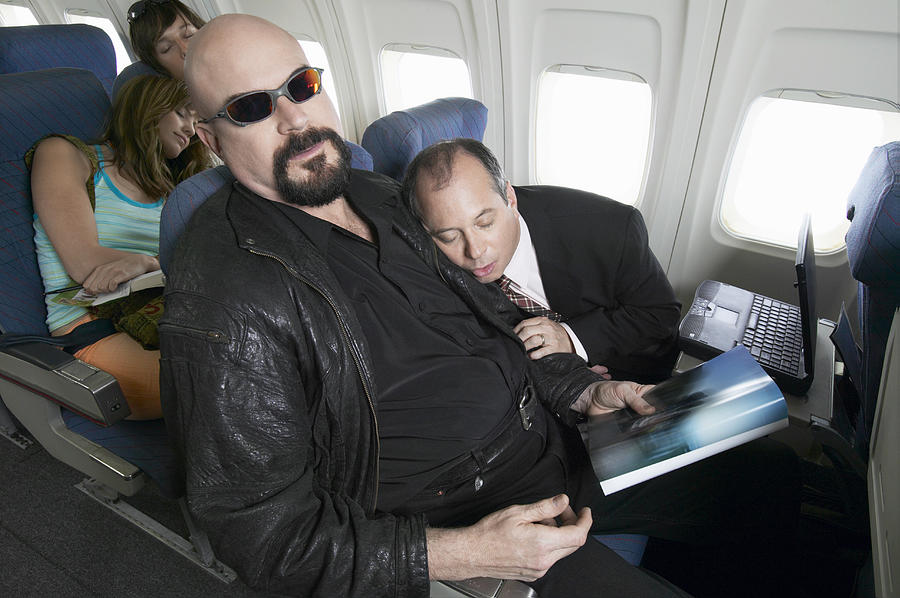 Plane Interior, Businessman Falling Asleep on the Man Sitting Next to Him Photograph by Digital Vision.