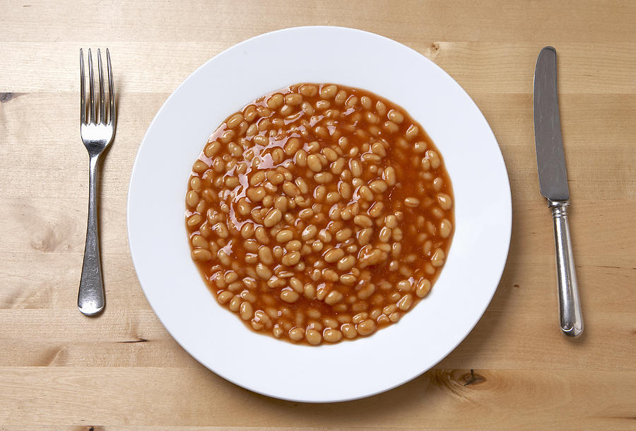 Plate of baked beans, overhead view Photograph by Andrew Olney