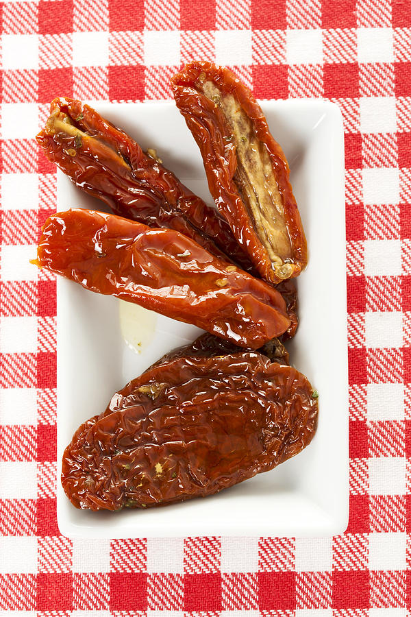 Plate of dried tomatoes, close up Photograph by Westend61