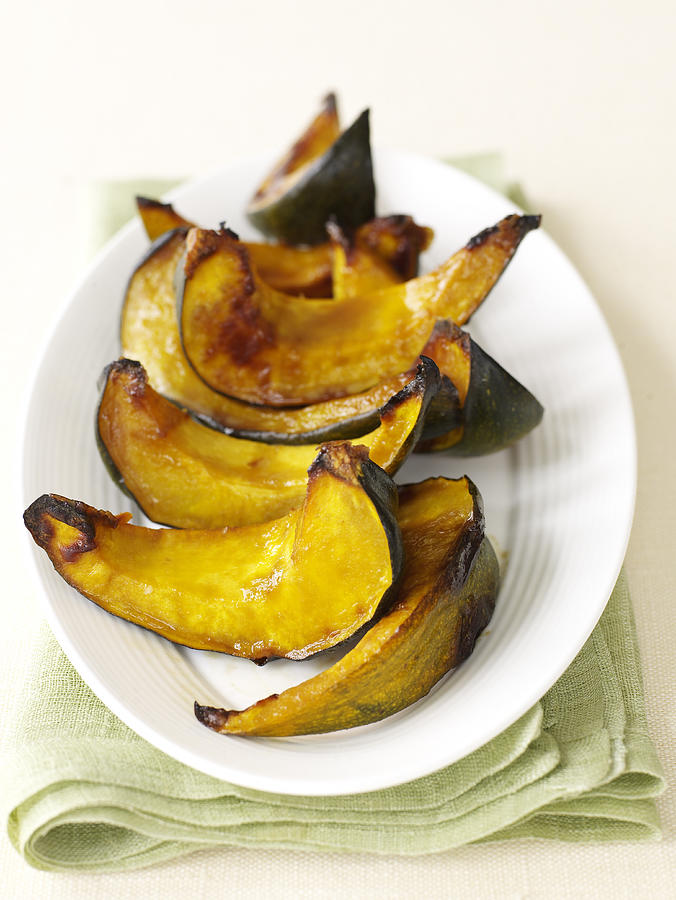 Platter of roasted acorn squash Photograph by James Baigrie
