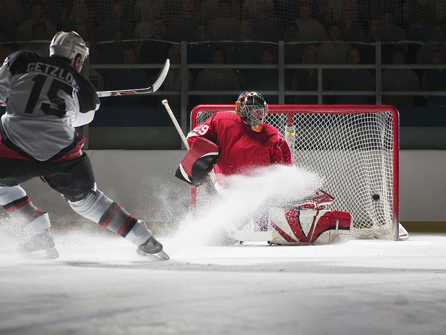 Player scoring a goal in ice hockey Photograph by Ryan McVay