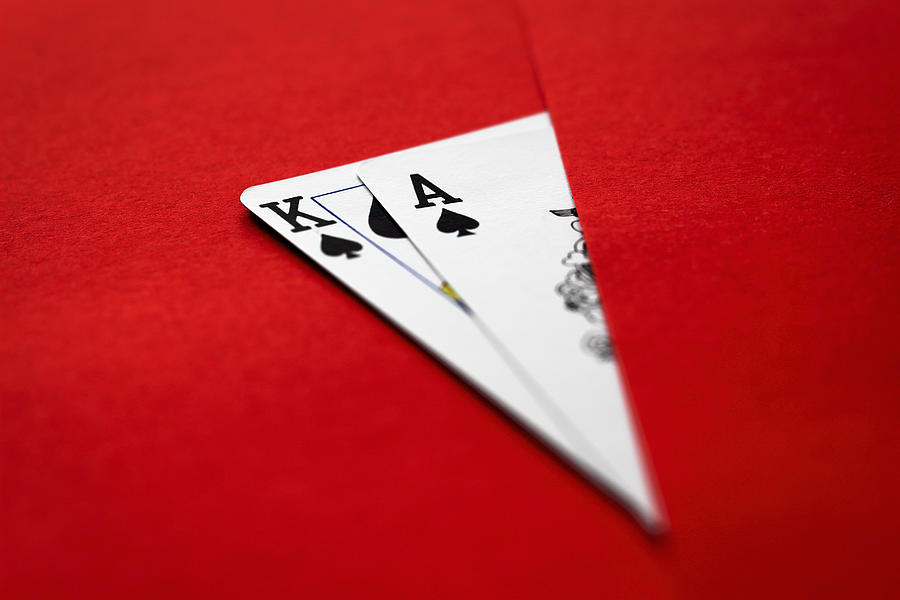 Playing cards, king and ace on red surface Photograph by Vlatko Gasparic