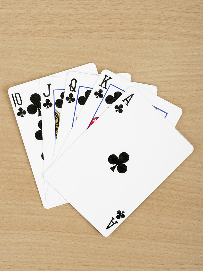 Playing cards showing royal flush, close up Photograph by Steven Puetzer