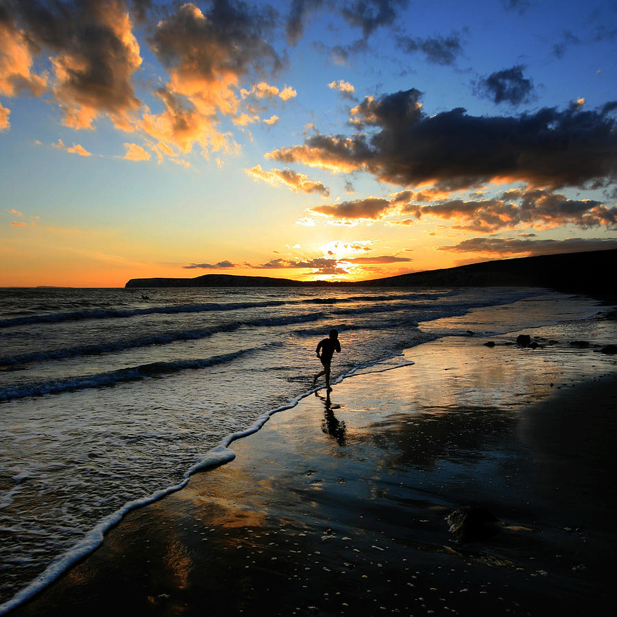 Playing  on coast at sunset  Photograph by s0ulsurfing - Jason Swain