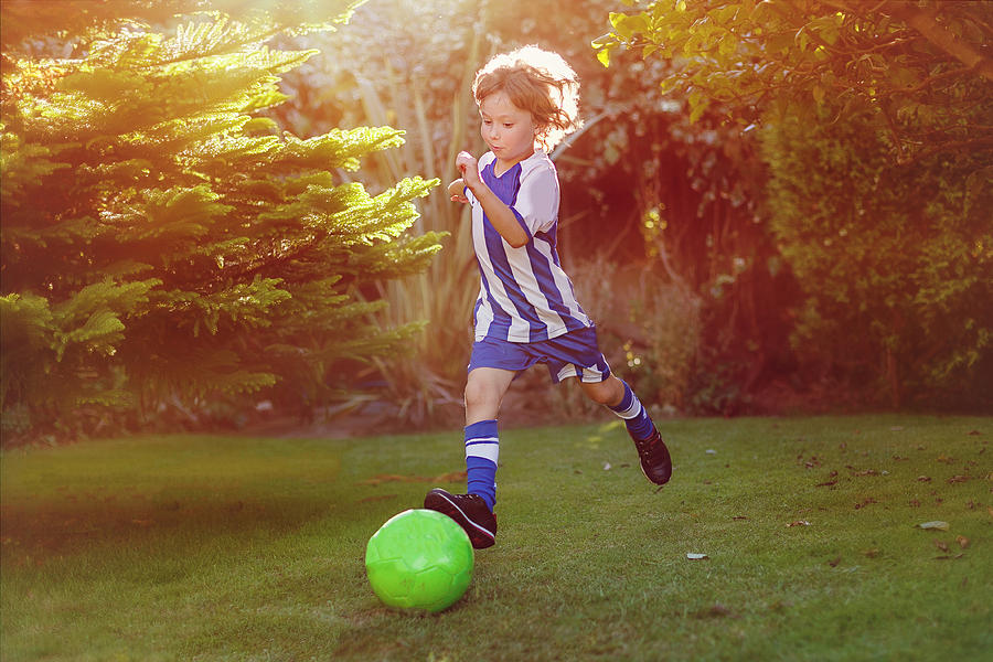 Playing soccer Photograph by Carol Yepes