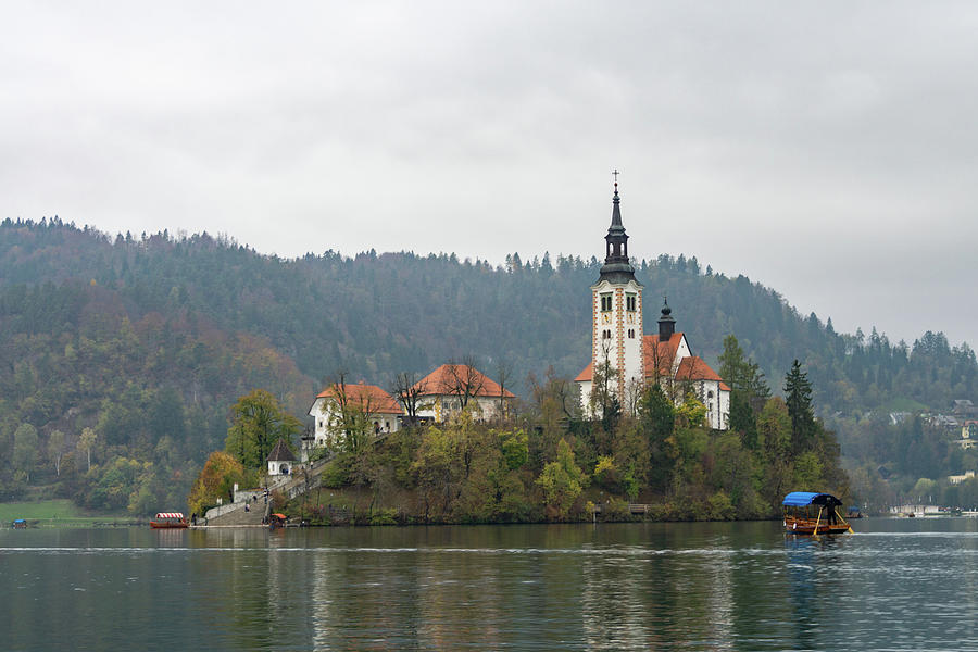 Pletna Boats Glide to Bled Island Photograph by Lindsay Thomson