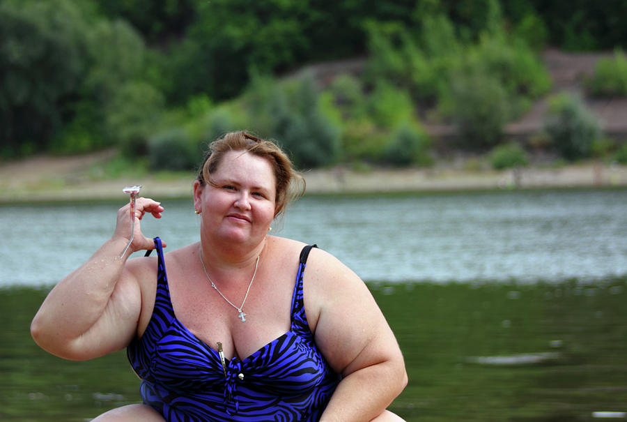 Plump Woman Sitting Near River Photograph by Mikhail Kokhanchikov