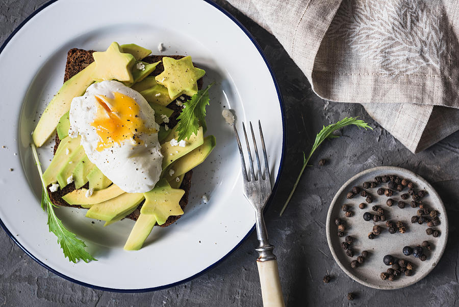 Poached egg and avocado on toast Photograph by Arx0nt