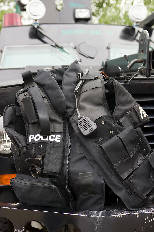 Police vest sitting on bumper of armored vehicle Photograph by Bryan Mullennix